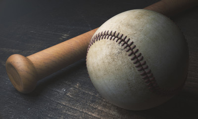 Baseball and bat on wooden surface