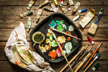 Artist (painter) atelier - brushes, palette and paints on wood