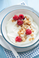 yogurt with granola and raspberry for healthy breakfast