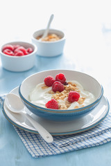 yogurt with granola and raspberry for healthy breakfast