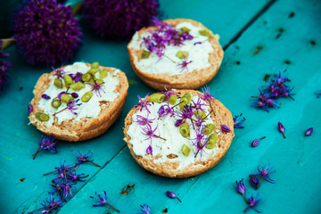 Closeup of flowering chives with shallow depth of field and focus concentrated on flower in the foreground