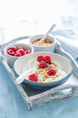 yogurt with granola and raspberry for healthy breakfast