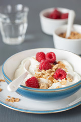 yogurt with granola and raspberry for healthy breakfast
