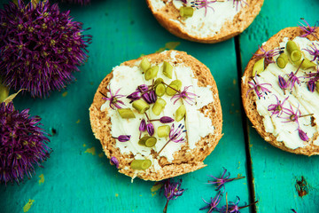 Closeup of flowering chives with shallow depth of field and focus concentrated on flower in the foreground