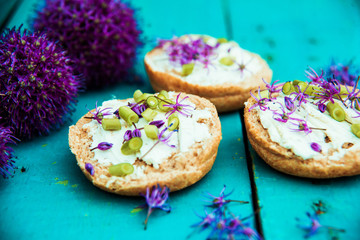 Closeup of flowering chives with shallow depth of field and focus concentrated on flower in the foreground