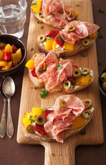 salami bruschetta with roasted peppers goat cheese olives