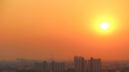 Blurred city / City is blurred by dust in the air under orange sky with big yellow sun