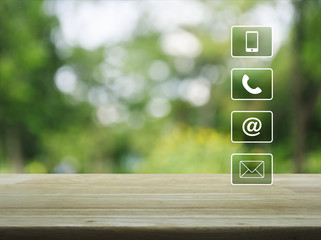 Telephone, mobile phone, at and email buttons on wooden table over blur green tree background, Customer support concept