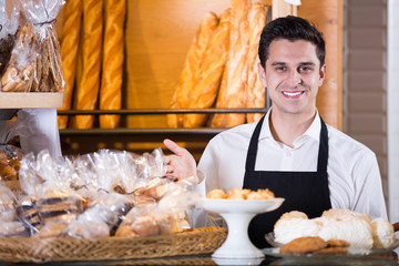 Man selling fresh pastry and baguettes
