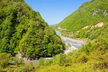 Fototapeta na wymiar River in mountains against blue sky. Georgia.