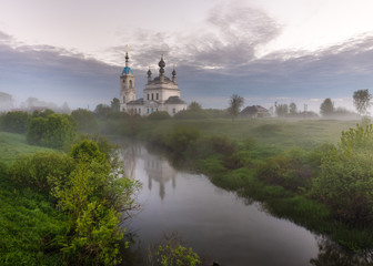 Foggy sunrise in the village Savinskoye, Yaroslavl region. Russia. The Church Of The Nativity Of The Blessed Virgin. 