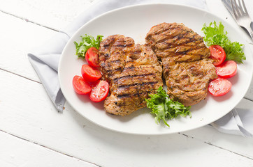 Grilled pork steak and vegetable salad