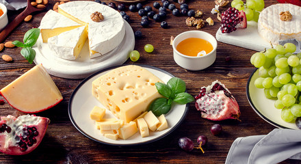 Cheeses with grapes  on  wooden table