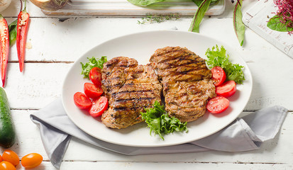 Grilled pork steak and vegetable salad
