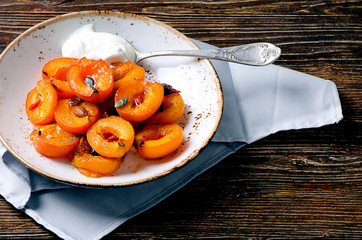 Baked apricots in bowl.