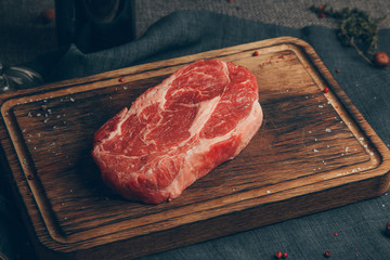 Raw meat in wood background