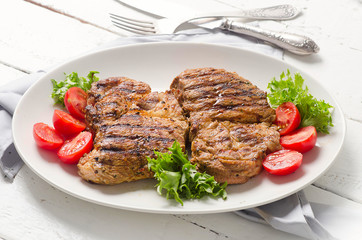 Grilled pork steak and vegetable salad