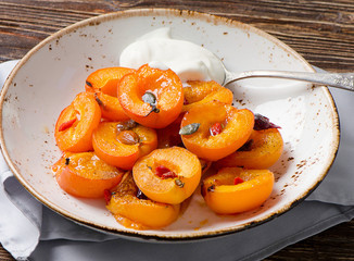 Baked apricots in bowl.