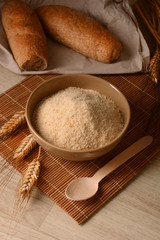 Bread crumbs in the bowl on the wooden table