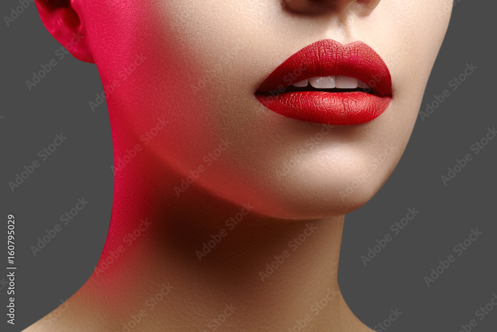 Wall mural Cosmetics, makeup. Bright lipstick on lips. Closeup of beautiful female mouth with red lip makeup. Clean skin model