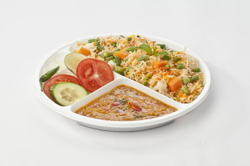 Indian meal combo with Vegetable biryani and daal mash  in disposable plate