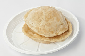 Puri on white disposable plate