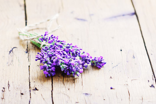 Bunch of lavender flowers on a rustic wooden background, copy space .