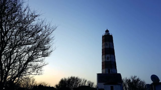 lighthouse with rotating spotlight during sunset shabla bulgaria 4K UHD