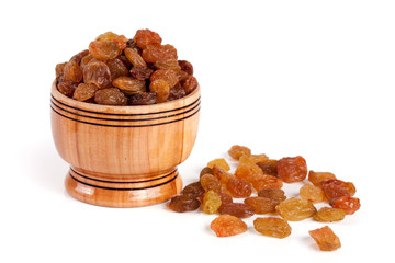 raisins in a wooden bowl isolated on white background