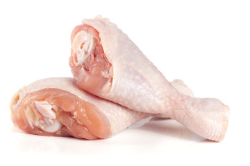 Two raw chicken drumsticks isolated on white background