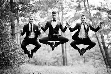 Awesome groom and groomsmen getting crazy in the forest and performing tricks on a wedding day.