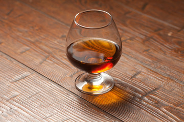 Brandy glass on the wooden table.