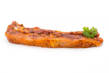 Spicy marinated spare ribs barbecued on the white background.