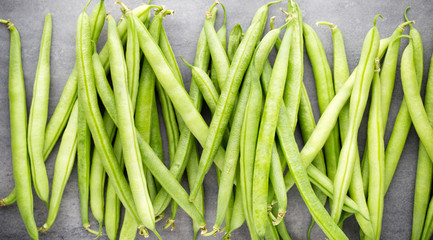 Green beans  on a gray background.