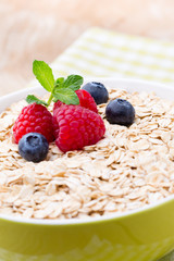 Oatmeal porridge with berries. Raspberries and blueberries.