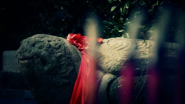 Stone turtle totem with Red ribbon,Burning incense in Incense burner,Wind of smoke.