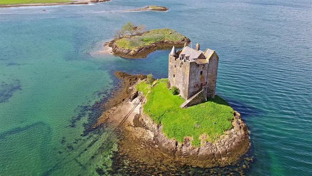 Aerial shot of medieval Castle Stalker on the west coast of Scotland by Appin