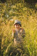 Smiling boy, making his way through the big grass