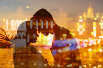 Double exposure of couple silhouette and night cityscape