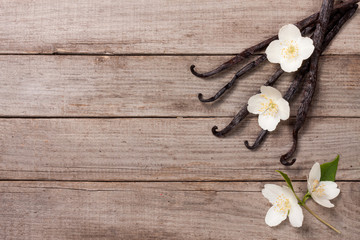 Vanilla sticks with flower and leaf on a old wooden background with copy space for your text. Top...
