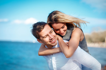 Couple in love having fun laughing and smiling at beach