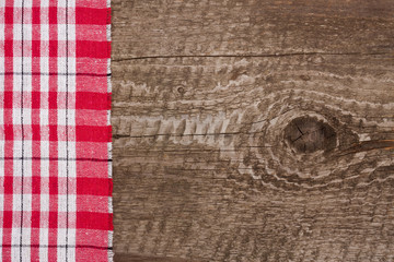 red checkered tablecloth on the old wooden table with copy space for your text. Top view