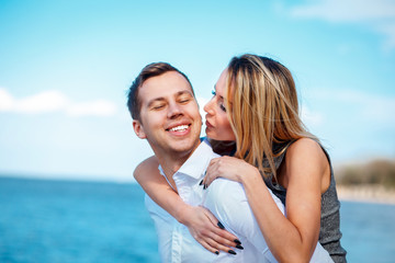 Couple in love having fun laughing and smiling at beach