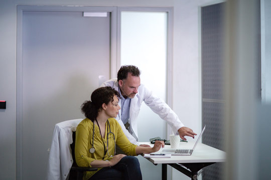 Medical Doctors discussing patient treatment together