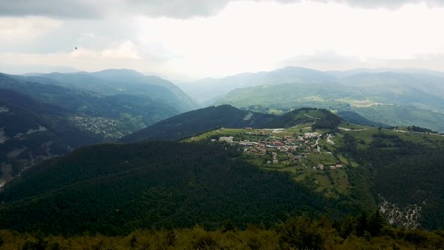 Panorama from Belintash of the village of Vrata, surrounded by pine forest in the Rhodope Mountains (Rhodopes, Bulgaria) 4K UHD