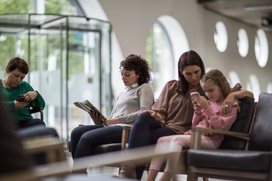 Women waiting in a crowded hospital waiting room
