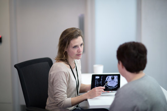 Female Medical Doctor explaining scan results to patient