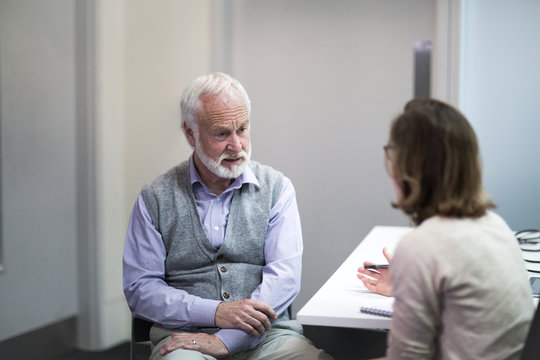 Female Medical Doctor listening to a Senior patient symptoms