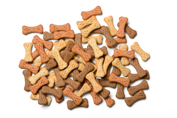 dog biscuits in the shape of bones in white background - closeup