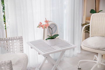 Beautiful modern veranda with cozy armchairs and coffee table